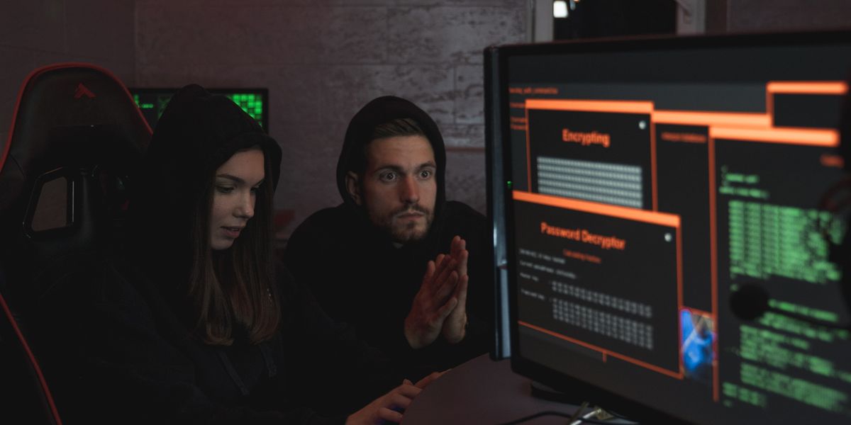 Cybersecurity professionals monitoring encrypted data on computer screens